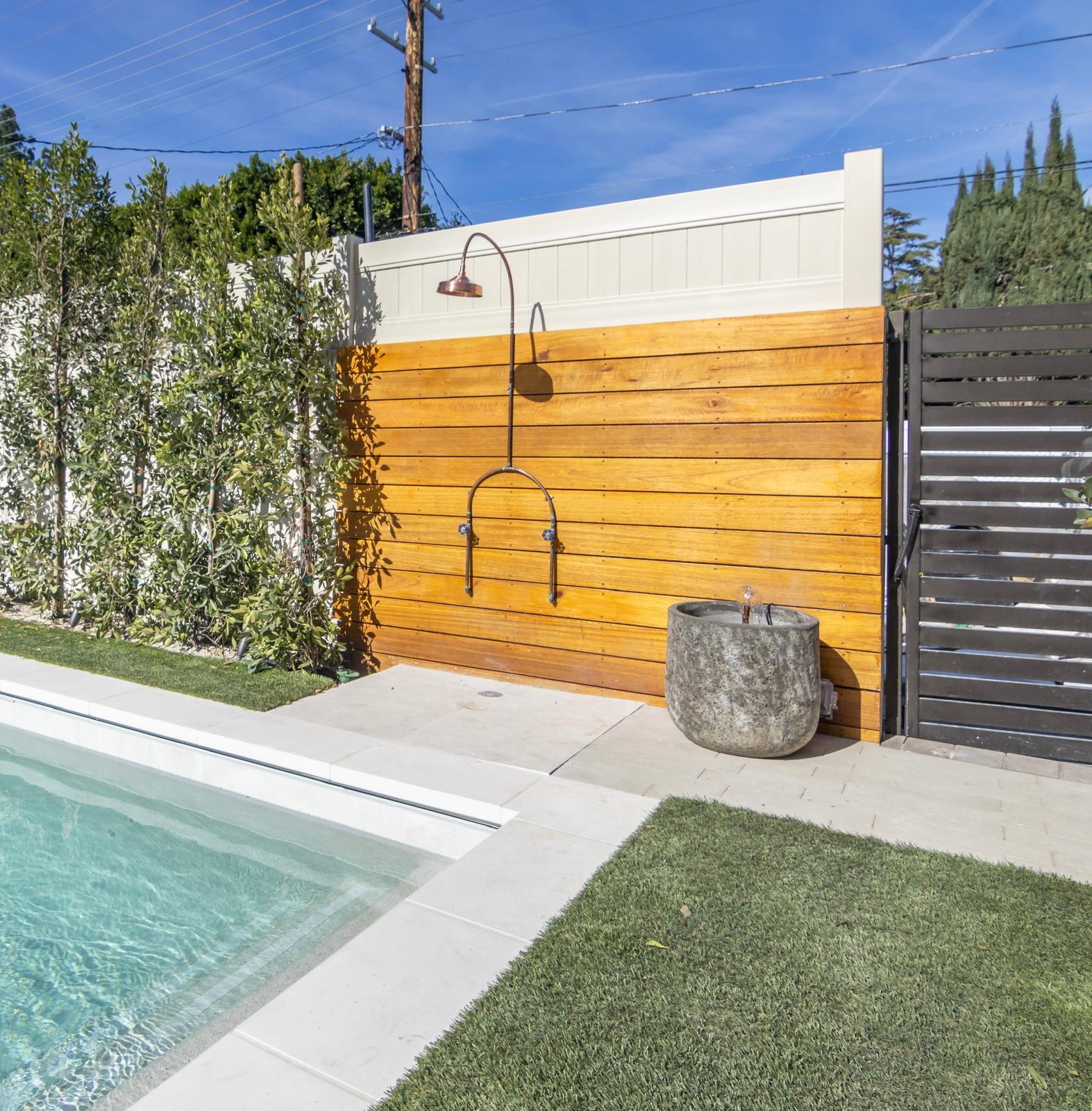 Custom pool with outdoor shower and luxury landscaping in West Hills by Pool Masters LA